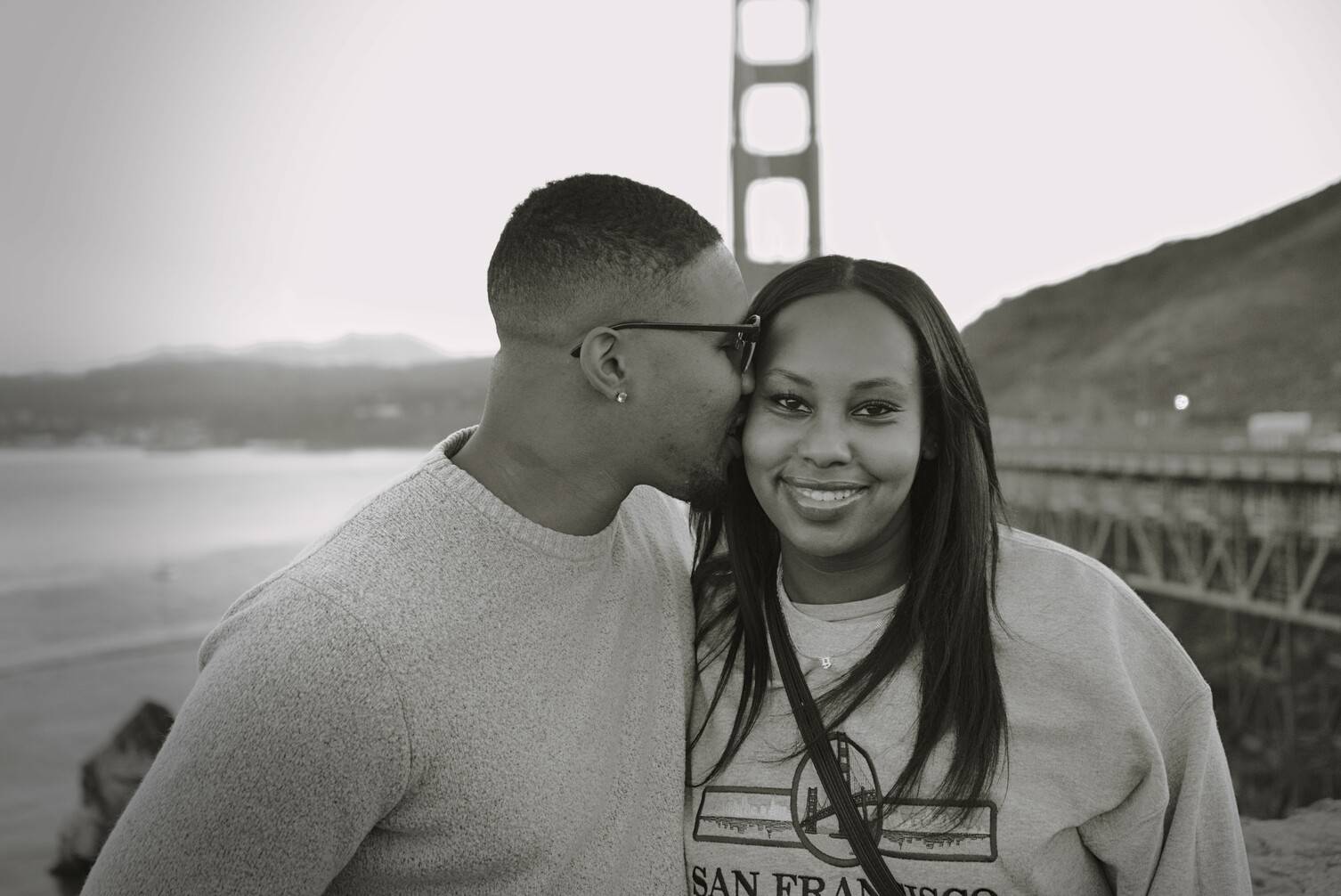 Beautiful Black couple shares a kiss at the Golden Gate Bridge Vista Point